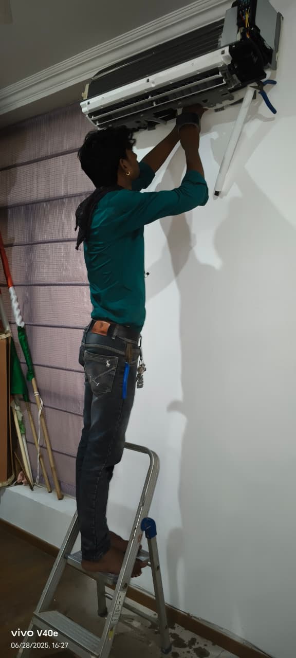 Technician working on an indoor AC unit
