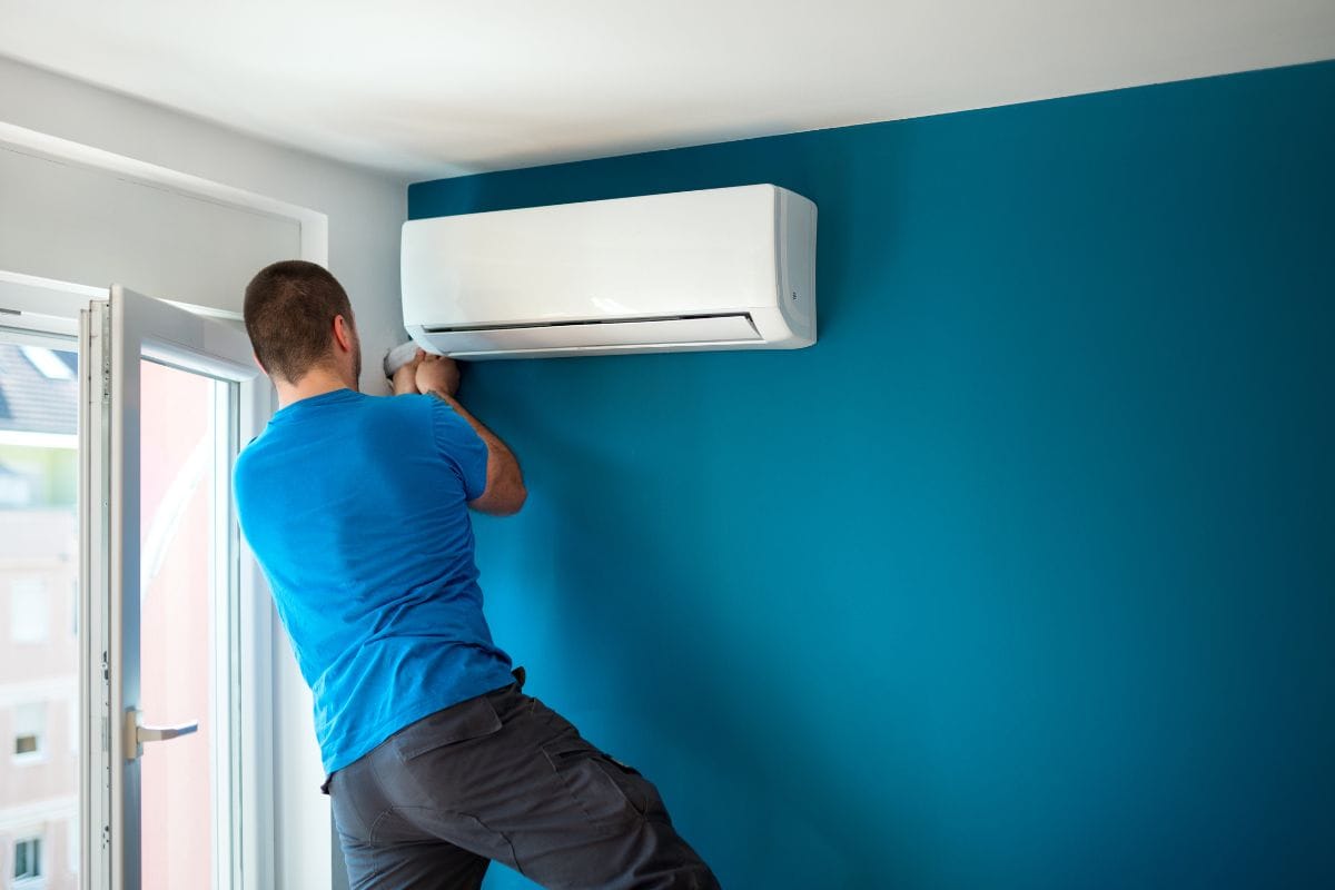 Technician installing a residential split air conditioner